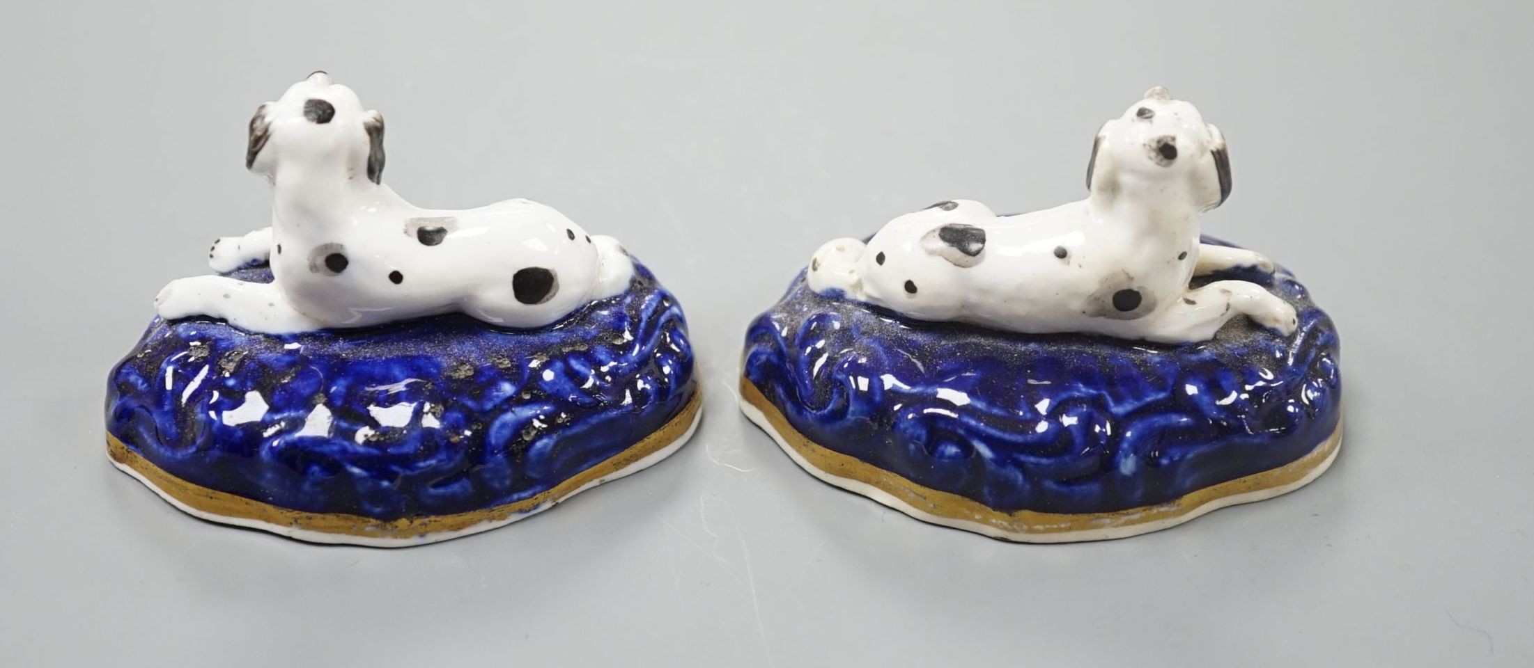A pair of Samuel Alcock porcelain models of recumbent king Charles spaniels, c.1835-40, impressed mark 18, 7.3 cm long , Cf. Dennis G.Rice Dogs in English porcelain, colour plate 136 and 137., Provenance: Dennis G.Rice c